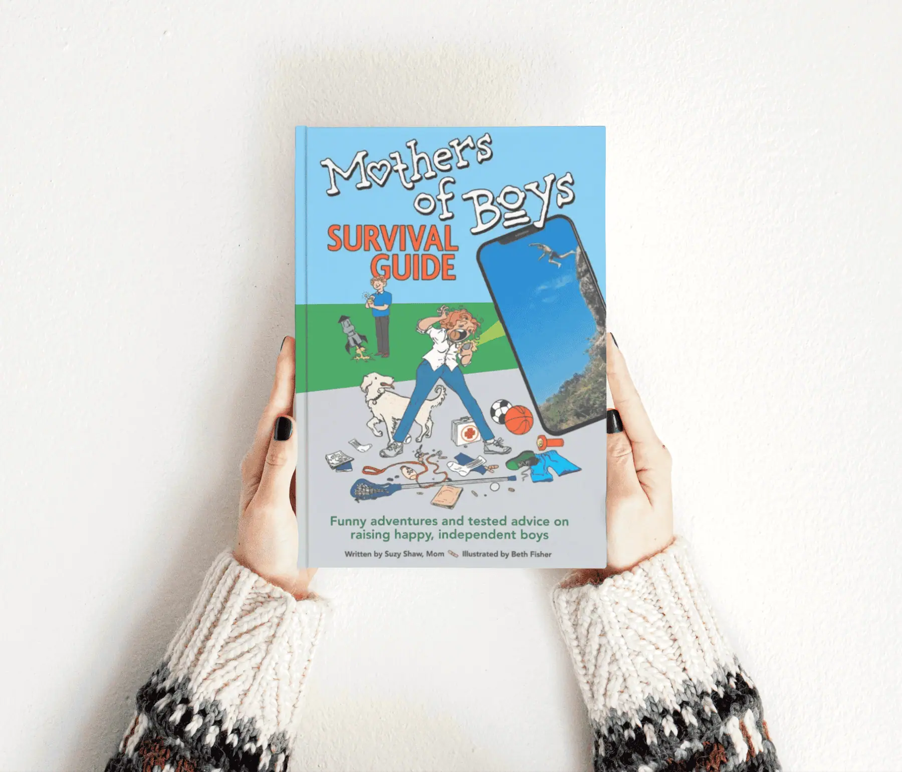 Mothers of Boys Survival Guide Mothers of Boys Survival Guide book held in woman's hands.